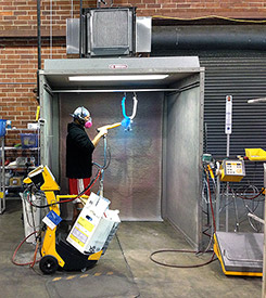 Powder coating a Catrike Road swing arm in Electric Blue.
